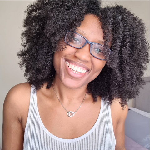 Woman with natural curly hair smiling